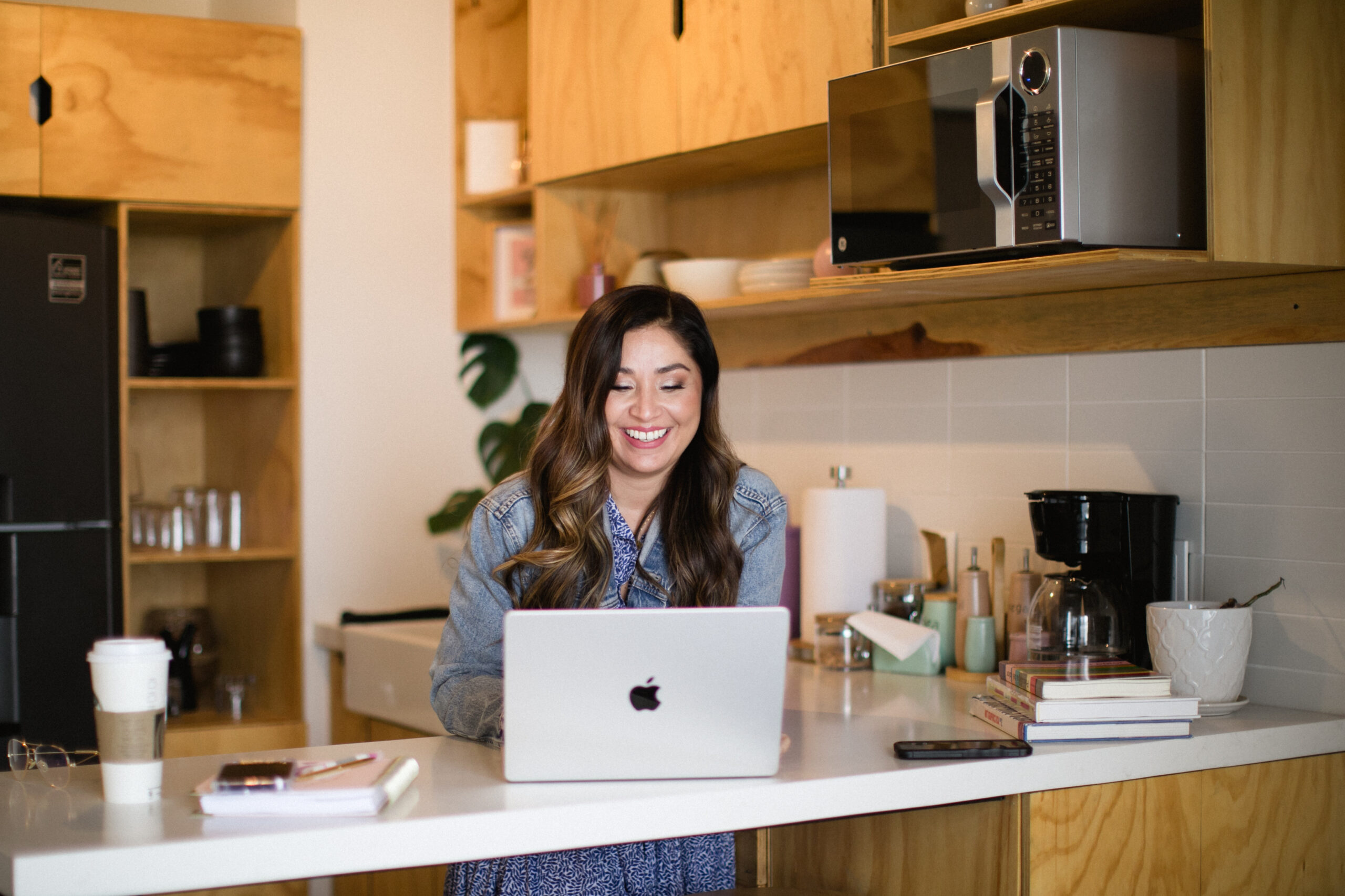 Ale Merino working in her computer in the counter of her kitchen